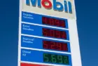 Mobil gas station sign showing high price of California Gasoline with bright blue sky Lone Pine^ CA^ USA - February 9th^ 2023