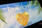 '2025 Love Island'' shown on a smart phone. is a reality dating show that originated in the UK. The premise involves a group of singles living together in a luxurious villa^ where they couple up Toronto^ Canada - June 5
