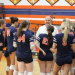 img_0386: The Lady Cougars huddle around Shane Decker following a fast start. 