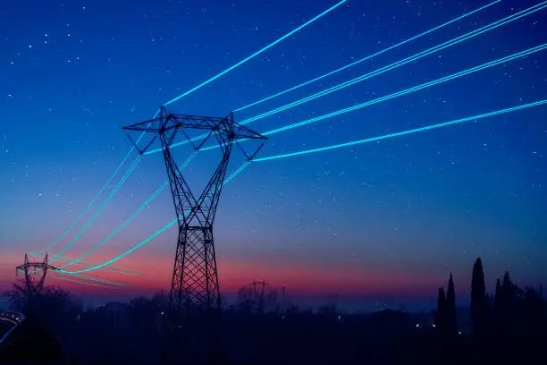 electricity-pilon-with-glowing-cables-over-sunset-sky