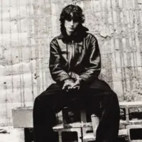 An Apple iPad displays the Spotify music streaming app. The screen the shows the song "undressed" by "Sombr" being played^ as well as the album cover art.