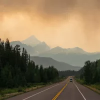 Dramatic landscape with smoke clouds along a highway in British Columbia during wildfires^ Canada.