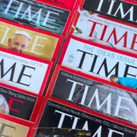 Colorful close-up of overlapping TIME Magazine covers^ highlighting diverse headlines on world leaders^ politics^ business^ and social issues. Calgary^ Alberta^ Canada. Dec 1^ 2025