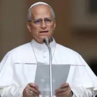 Pope Leo XIV recites the Angelus and imparts his blessing at the gates of the Apostolic Palace before thousands of faithful in Castelgandolfo. Castelgandolfo^ Italy - August 17^ 2025