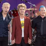 Mike Dirnt^ Billie Joe Armstrong^ Tre Cool pose on stage during ABC Good Morning America rock group Green Day concert in Central Park in New York on July 26^ 2024