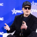 Elon Musk speaks with Newsmax Host Rob Schmitt on day 1 of the 2025 Conservative Political Action Conference. NATIONAL HARBOR^ MD^ USA — February 20 2025