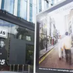 Oasis album cover artwork on display outside the Oasis live 25 shop in Manchester Manchester^ UK - 26 June 2025