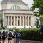 Students in the Columbia University campus on the Upper West Side of Manhattan. Steps of the Low Memorial Library in the background. New York^ NY^ USA - July 8^ 2022