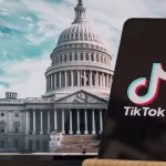 TikTok sign is sharp in the foreground^ while American Congress building is blurred in the background^ concept for TikTok ban in the United States^ USA^ March 8^ 2024