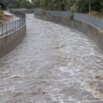 A high Los Angeles River rushes under Sepulveda Boulevard during flash flooding. August 20^2023