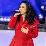 Demi Lovato wearing dress by Michael Ngo performs on stage during American Heart Association Go Red for Women and Red Dress Collection Concert at Jazz at Lincoln Center in New York on Jan 31^ 2024.