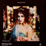 An Apple iPad displays the Spotify music streaming app. The screen the shows the song "Pink Pony Club" by "Chappell Roan" being played^ as well as the album cover art.