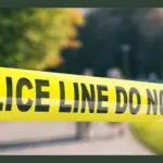 Police line outdoors. Warning yellow tape^ text police line do not cross^ blur park nature background. 3d illustration