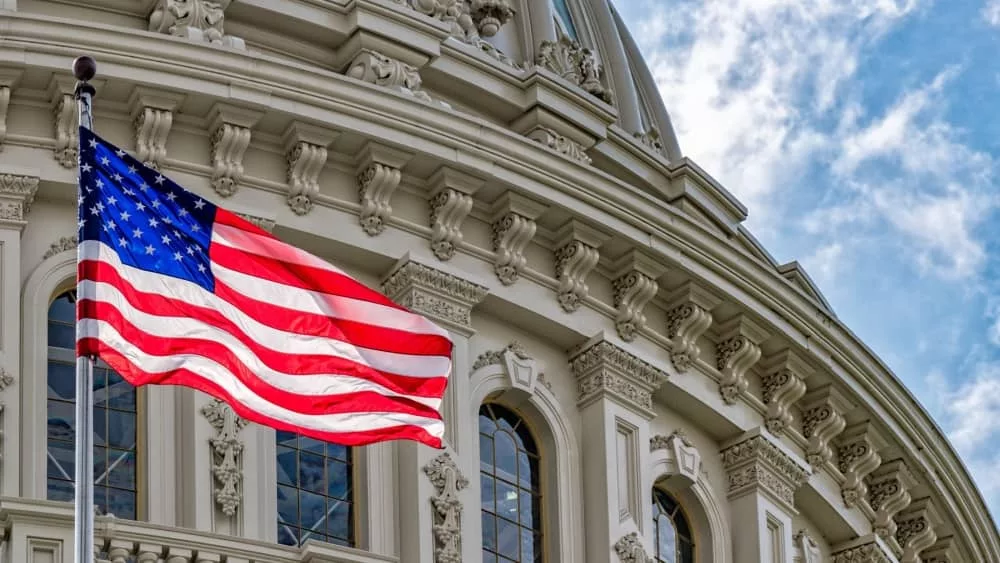 Washington DC Capitol dome detail with waving american flag