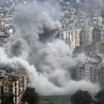 Large plumes of grey smoke billow from mult story apartment buildings following an explosion in a densely populated city^ depicting the devastation of modern urban warfare. Jan 28 2026 in USA