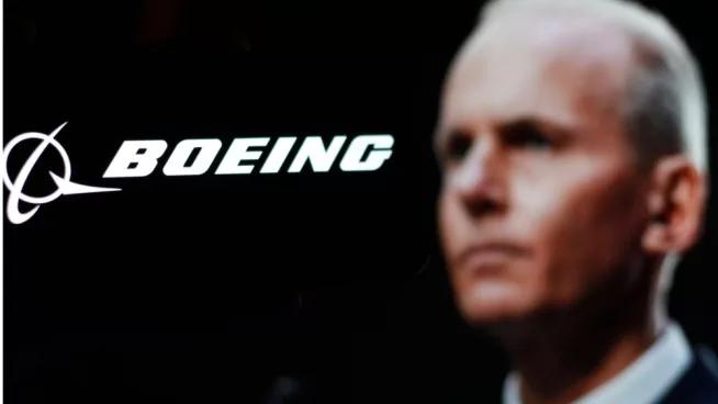 Logo of the Boeing Company^ with CEO Dave Calhoun in the background