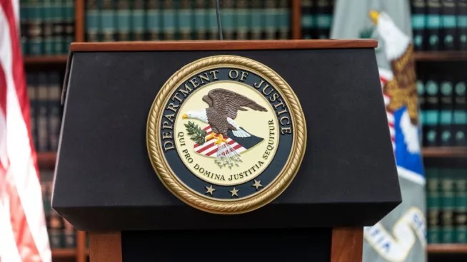 Seal of Justice Department seen during press conference at US Attorney Office library