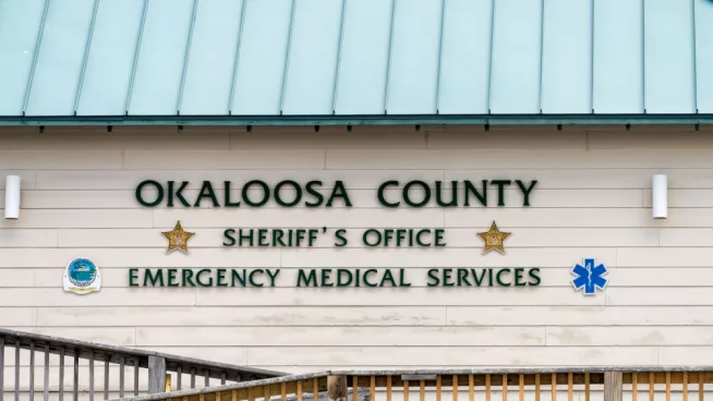 Okaloosa Island county Sheriff's Office emergency medical services building with sign by beach by ramp in Florida Panhandle^ Gulf of Mexico