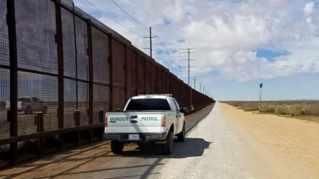 U.S. Customs and Border Patrol vehicle drives along the U.S.-Mexico border. El Paso^ Texas / USA - March 7^ 2020