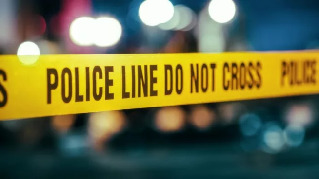 Yellow Tape Showing Text "Police Line Do Not Cross" Restricting a Crime Scene Area At Night. Close Up Aesthetic Shot with Bokeh Effect and Flickering Lights.