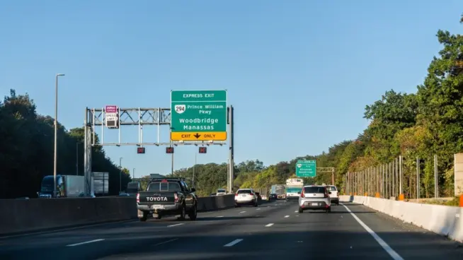 Highway i-95 interstate road in Virginia with cars on commute in morning traffic near Washington DC and sign for Prince William Parkway and ManassasWoodbridge^ USA - October 18^ 2021: