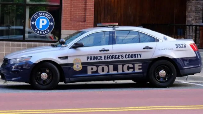 Prince George's County^ Maryland police car sits parked on a street in National Harbor in front of a public parking garage.