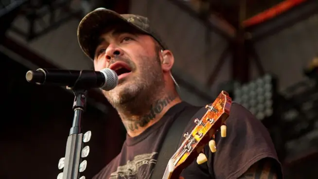 Aaron Lewis plays his guitar druing the performance of Staind Rockstar Uproar Festival on September 25^ 2012 in Nampa^ Idaho.