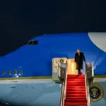 President Donald Trump arrives at Palm Beach aboard Airforce One at night. Red carpet stairs Palm Beach International Airport. 2026 January 1