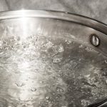 stainless-steel-pot-is-on-a-gas-stove-and-it-boils-water