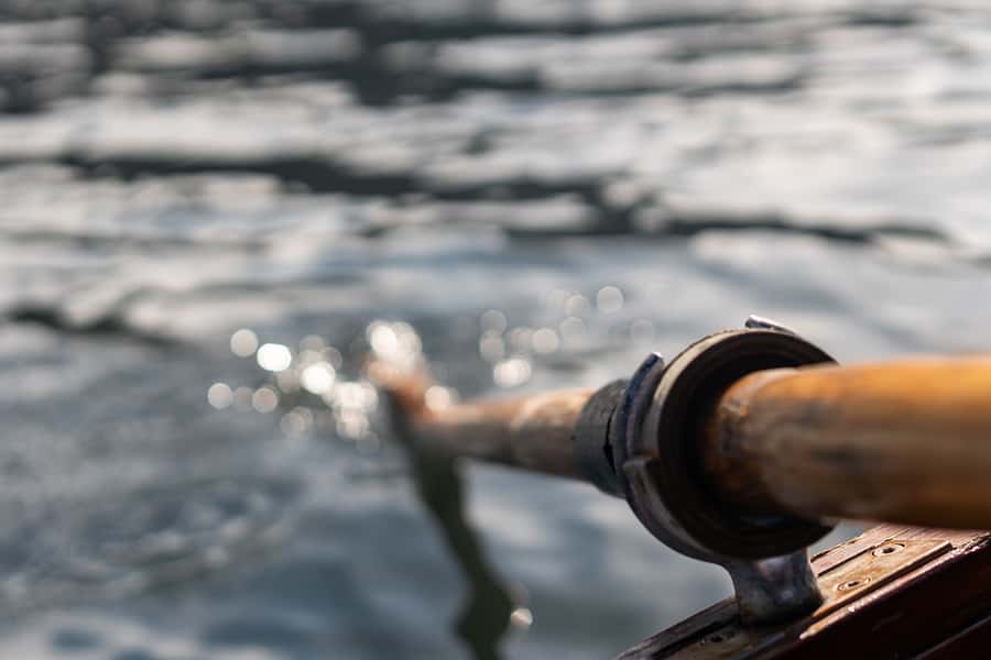 closeup-photo-of-wooden-paddle-attached-to-boat-used-for-rowing