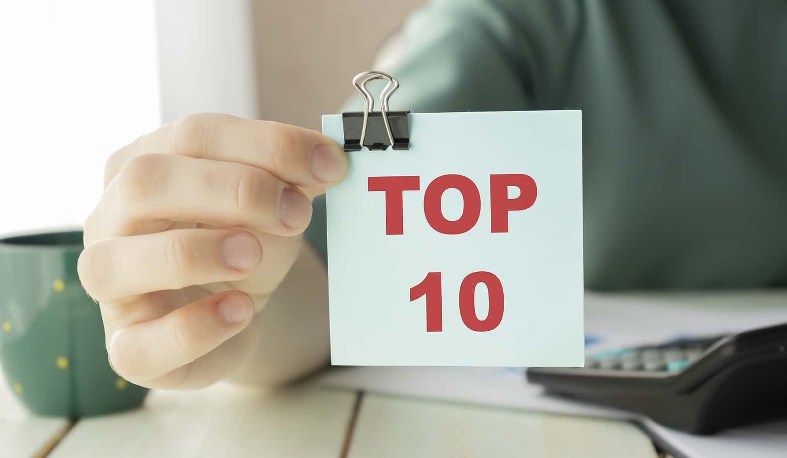 closeup-businesswoman-hands-holding-white-card-sign-with-top-10