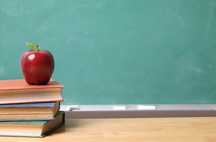 apple-on-school-books-with-copy-space-on-chalk-board