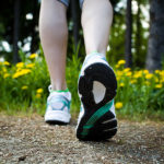 woman-walking-cross-country-and-trail-in-spring-forest