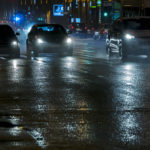 cars-driving-in-the-night-city-street-after-heavy-rain