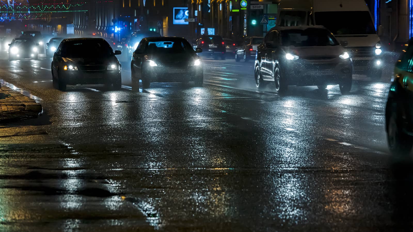 cars-driving-in-the-night-city-street-after-heavy-rain
