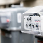 row-of-gray-natural-gas-meters-at-an-apartment-complex