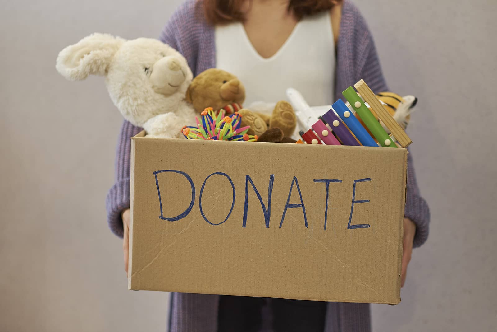 donation-box-with-children-toys-woman-collects-toys-for-charity