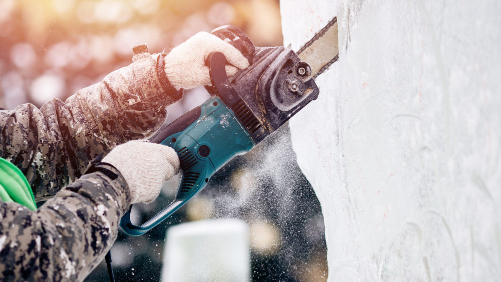 ice-sculpture-carving-man-use-chainsaw-cut-frozen-winter