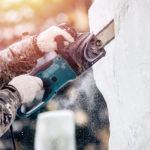 ice-sculpture-carving-man-use-chainsaw-cut-frozen-winter