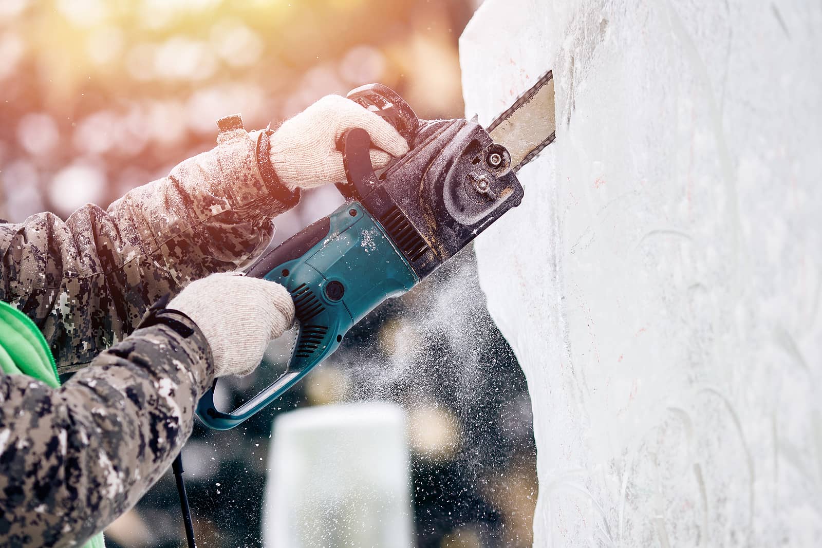 ice-sculpture-carving-man-use-chainsaw-cut-frozen-winter