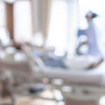 nurse-nursing-patient-on-hospital-bed-blur-background-medical-b
