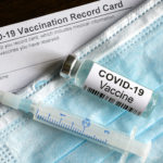covid-19-vaccine-bottle-syringe-surgical-mask-and-coronavirus