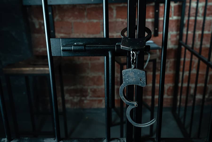 closeup-of-handcuffs-hanging-on-jail-bars-the-handcuffs-are-han
