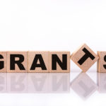 grants-word-text-written-on-wooden-cubes-on-a-white-background