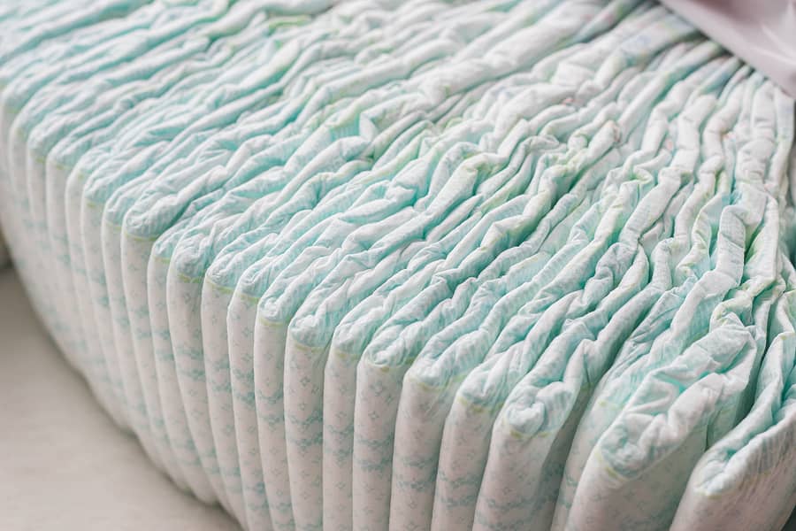 a-large-stack-of-baby-diapers-close-ups-diaper-packaging-whit