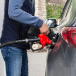 man-fills-his-black-car-with-fuel-at-gas-station-pumps-up-gasol