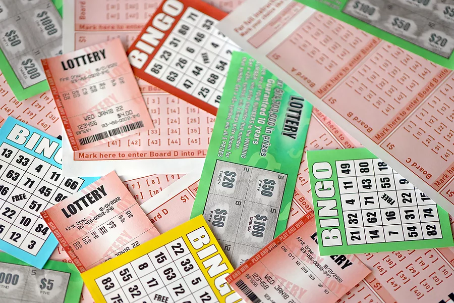 many-used-lottery-tickets-bills-with-numbers-and-bingo-playing