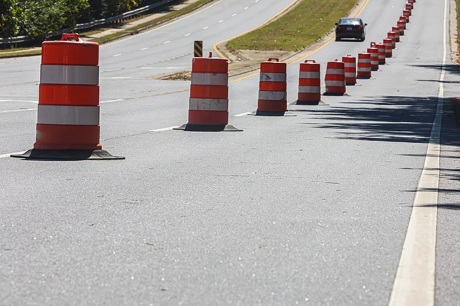 dozens-of-orange-and-white-road-construction-barrels-form-a-long