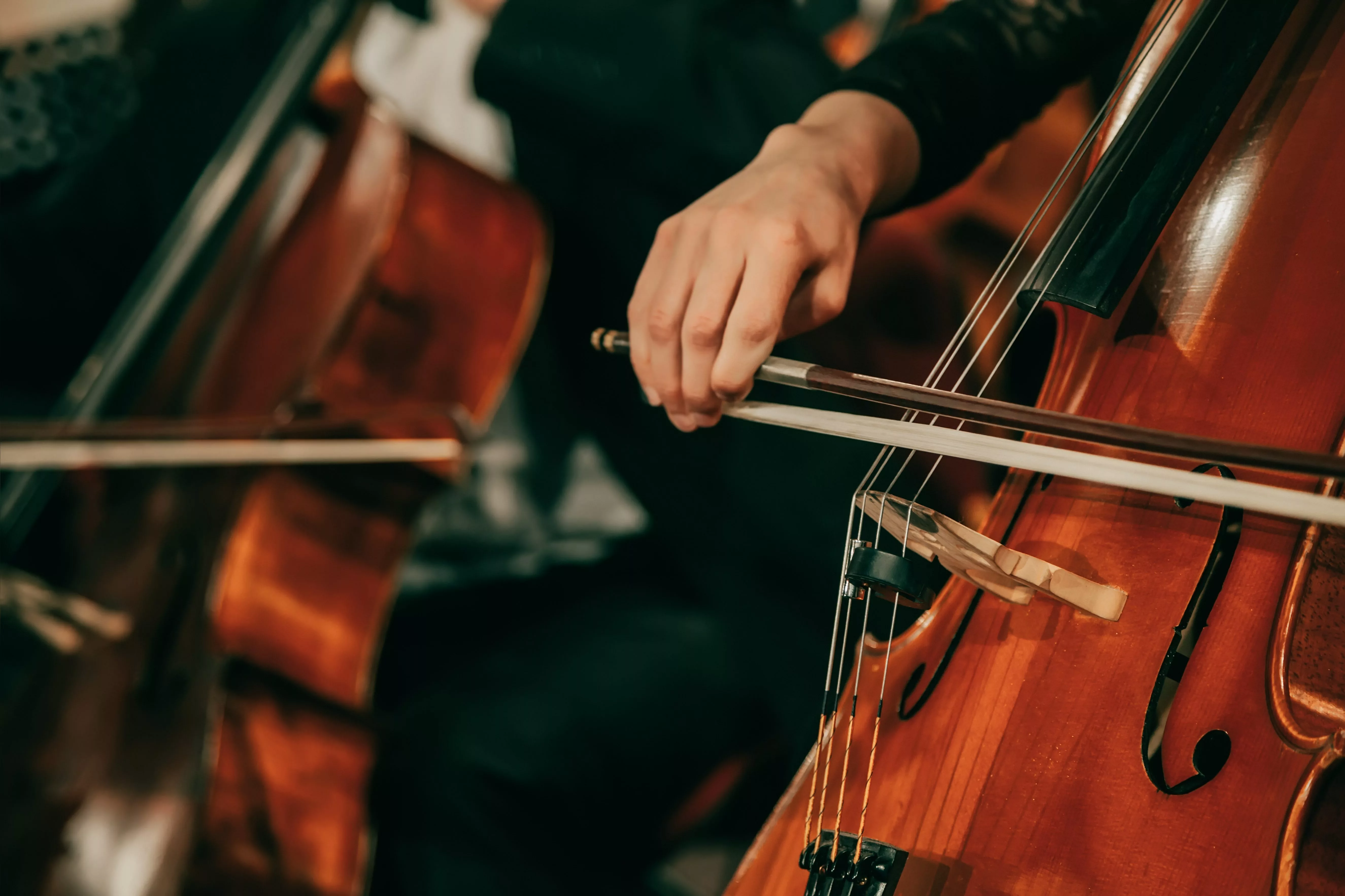 symphony-orchestra-on-stage-hands-playing-cello
