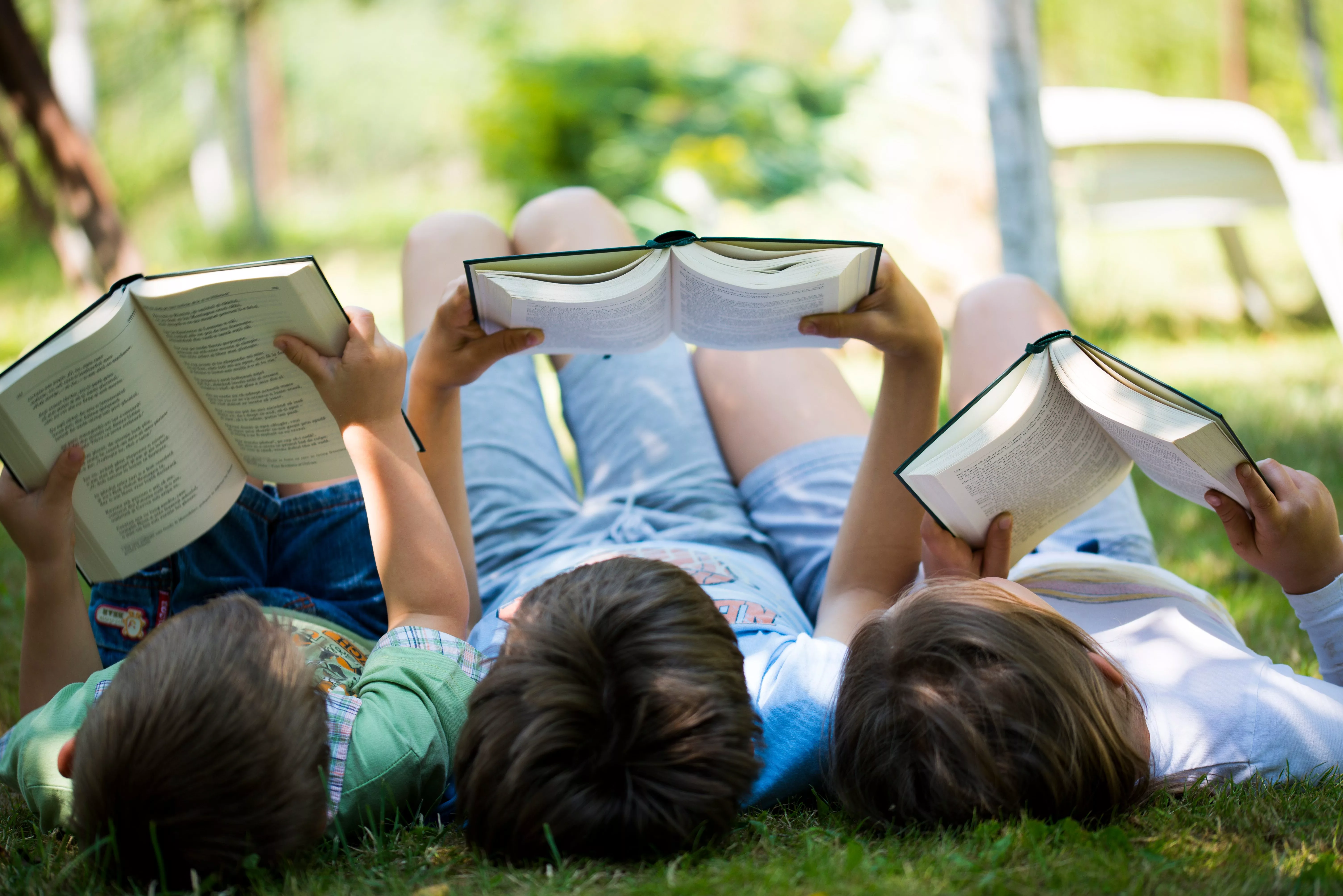 three-children-reading-in-the-garden
